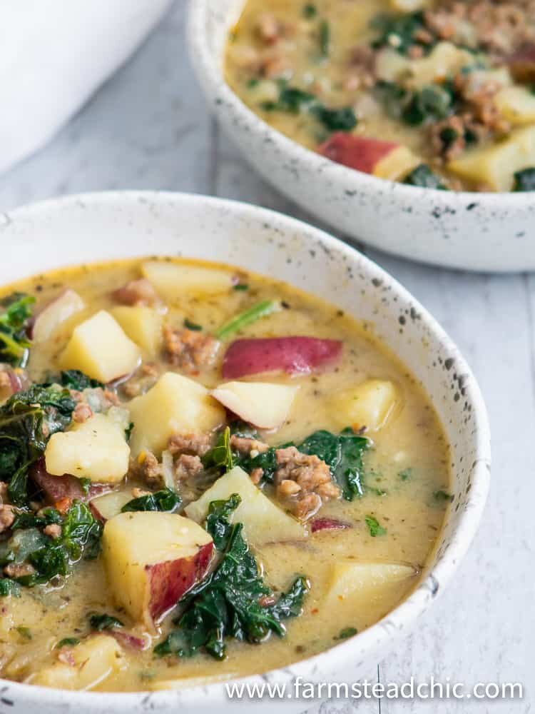 Cozy up to this Whole30 Zuppa Toscana (Dairy-Free Potato Soup Recipe) tonight! Packed with potatoes, sausage and fresh crunchy kale swimming in a lightly spiced broth, you'll think you're at Olive Garden (minus the guilt)! You'll fall in love with this healthy, dairy-free, gluten-free Olive Garden Zuppa Toscana copycat recipe once you give it a try.