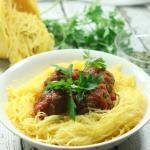 These giant-sized Paleo & Whole30 Italian Meatballs with Spaghetti Squash are tasty, healthy and easy to make in the slow cooker for a fuss-free dinner!