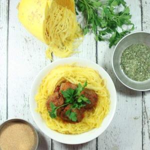These giant-sized Paleo & Whole30 Italian Meatballs with Spaghetti Squash are tasty, healthy and easy to make in the slow cooker for a fuss-free dinner!