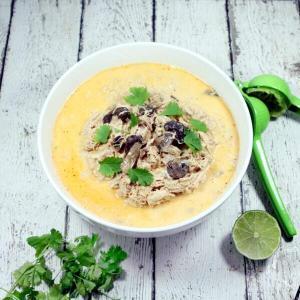 Creamy and spicy with hints of lime, this easy + healthy Paleo and Whole30 Coconut Curry Chicken Soup is the perfect slow cooker meal.