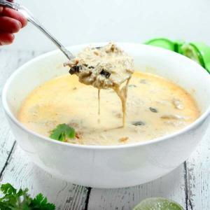 Creamy and spicy with hints of lime, this easy + healthy Paleo and Whole30 Coconut Curry Chicken Soup is the perfect slow cooker meal.