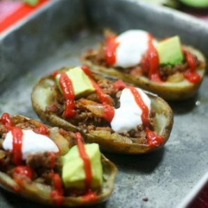 These Whole30 Beefy Taco Potato Skins are crispy and buttery, filled with savory taco meat, tomatoes + onions with an endless array of toppings. Dairy-free!