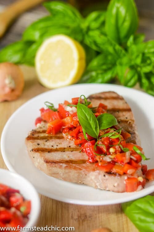 This Paleo and Whole30 Grilled Ahi Tuna with Roasted Red Pepper Relish is super simple to make but bursting with flavor.  With ingredients like jarred roasted red peppers, lemon juice, thyme and fresh basil, it's the perfect healthy (20 minute) grilled summer dinner!