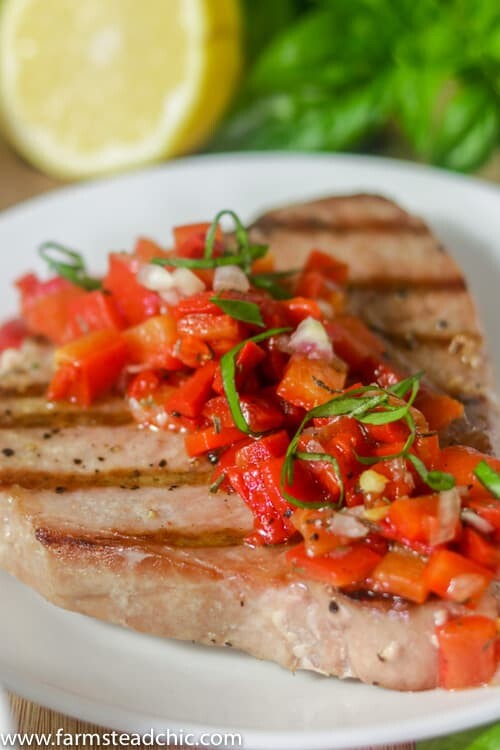 This Paleo and Whole30 Grilled Ahi Tuna with Roasted Red Pepper Relish is super simple to make but bursting with flavor.  With ingredients like jarred roasted red peppers, lemon juice, thyme and fresh basil, it's the perfect healthy (20 minute) grilled summer dinner!