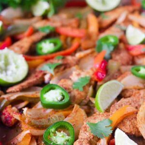 This Paleo and Whole30 Chicken Fajitas Sheet Pan Dinner is simple and easy with minimal cleanup! Serve it with some lime wedges, cilantro and guacamole.
