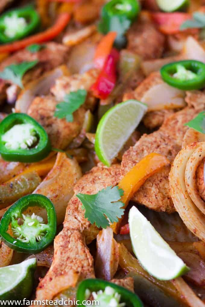 This Paleo and Whole30 Chicken Fajitas Sheet Pan Dinner is simple and easy with minimal cleanup! Serve it with some lime wedges, cilantro and guacamole.