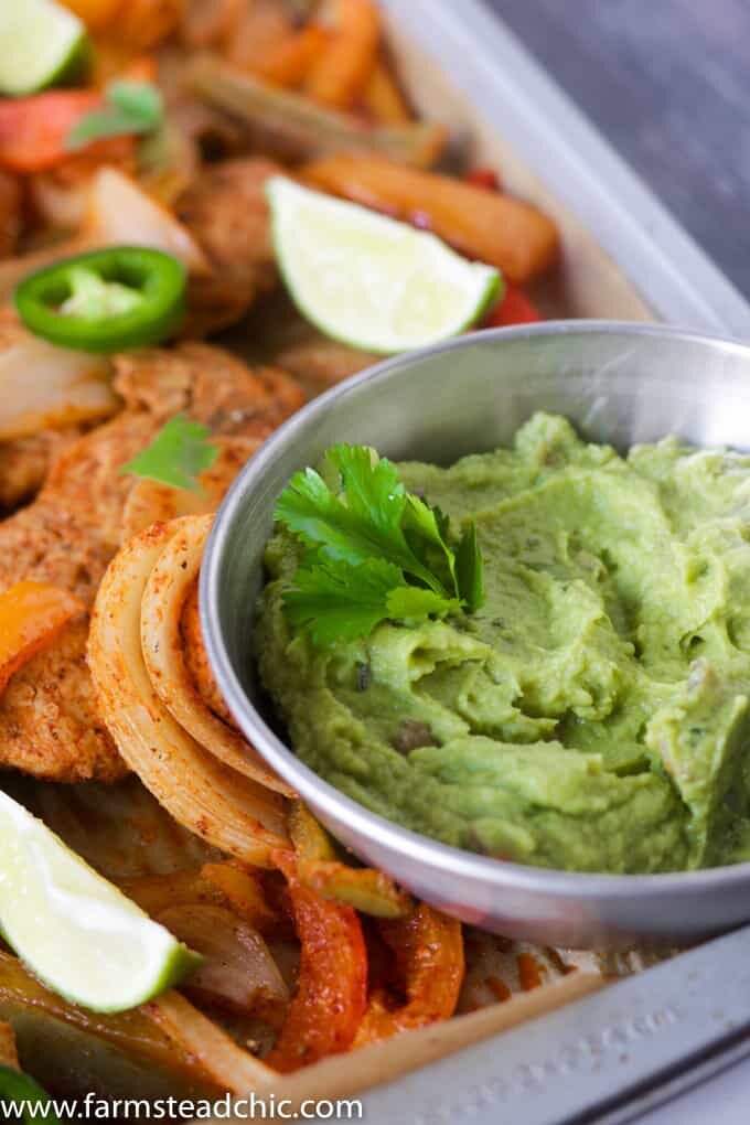This Paleo and Whole30 Chicken Fajitas Sheet Pan Dinner is simple and easy with minimal cleanup! Serve it with some lime wedges, cilantro and guacamole.