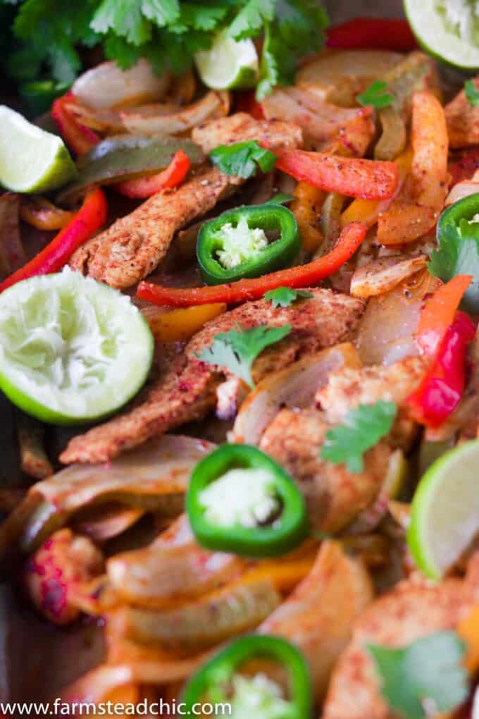 This Paleo and Whole30 Chicken Fajitas Sheet Pan Dinner is simple and easy with minimal cleanup! Serve it with some lime wedges, cilantro and guacamole.