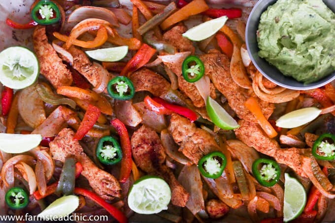 This Paleo and Whole30 Chicken Fajitas Sheet Pan Dinner is simple and easy with minimal cleanup! Serve it with some lime wedges, cilantro and guacamole.
