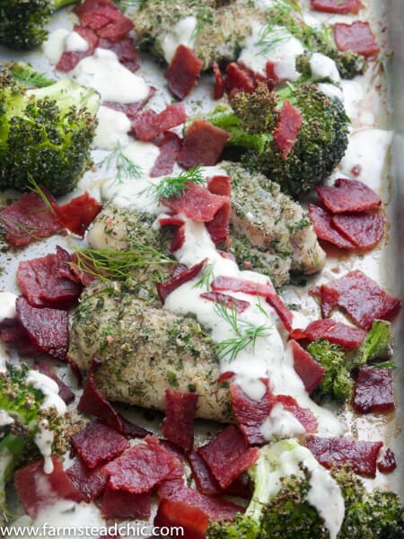 This Paleo and Whole30 Chicken Bacon Ranch Sheet Pan Dinner combines tender, juicy chicken thighs with roasted broccoli, crispy bacon and typical ranch dressing herbs and seasonings like chives, dill, parsley and onion and garlic powder into a one-dish, quick and tasty sheet pan dinner. Gluten free, grain free, dairy free, low carb.