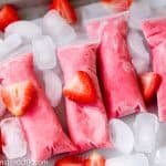 These Paleo Strawberry Coconut Popsicles are the perfect summer treat. Made with Whole30-compliant ingredients like strawberries, coconut milk, pineapple juice and OJ, they are healthy yet incredibly tasty. Dairy free, vegan and vegetarian-friendly.