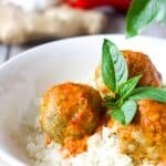Low Carb, Keto Curry Turkey Meatballs served over cauliflower rice and topped with red curry sauce and fresh Thai basil