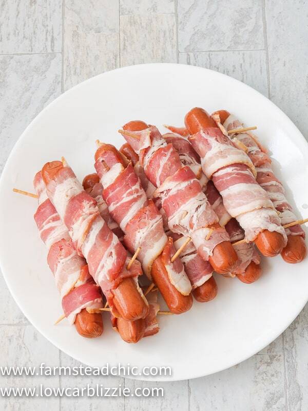 These Low Carb, Keto BBQ Bacon-Wrapped Hot Dogs are sure to be a hit with everyone, especially the kiddos. Who can say no to a grilled hot dog wrapped in bacon and slathered with a sweet and spicy (if you want) barbecue sauce? You only need three ingredients, ten minutes and a grill to get these puppies started. Come on! 