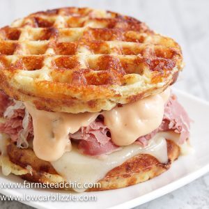 The perfect Chaffle bread, shaved corn beef, juicy sauerkraut, crunchy dill pickles, melty Swiss cheese and Thousand Island dressing make this Keto Reuben Chaffle taste better than the real thing without all the harmful additives and questionable ingredients.  #ketoreuben #reubenchaffle #lowcarbreuben #lowcarbsandwich #chaffle #farmsteadchic 