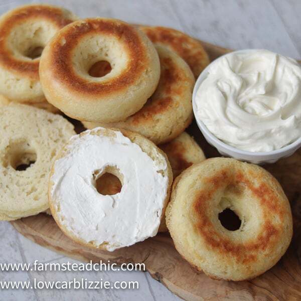 These Low Carb, Keto Bagels are based on the Fathead dough recipe and use mozzarella cheese, cream cheese, almond flour and eggs to make a dough that's surprisingly light and cream-cheese-spreadable. Add some smoked salmon, capers and sliced red onion for a Bagel and Lox. #farmsteadchic #lowcarbbagel #ketobagel #bagelandlox #smokedsalmonbagel #fatheadbagel #lowcarbbreakfast #ketobreakfast