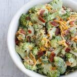 This Low Carb, Keto Broccoli Salad is made with fresh, raw broccoli, crispy fried bacon, shredded cheddar and creamy mayonnaise. It's a great fresh and crunchy addition to your holiday potluck or summer BBQ. | www.farmsteadchic.com | #ketobroccolisalad #lowcarbbroccolisalad #farmsteadchic #ketoholiday #lowcarbholiday #ketoBBQ #lowcarbBBQ #broccolisalad