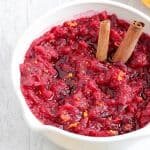 This Low Carb, Keto Cranberry Sauce has a citrus-cinnamon twist and is the perfect complement to your holiday spread. Fresh orange zest and orange extract replace the sugary orange juice found in most cranberry-orange sauces, and a monk fruit blend brings plenty of sweetness without all of those carbs.  #farmsteadchic #cranberrysauce #ketocranberrysauce #lowcarbcranberrysauce #ketoholiday #lowcarbholiday #thanksgivingrecipes #Christmasrecipes #ketothanksgivingrecipes #ketoChristmasrecipes #lowcarbthanksgivingrecipes #lowcarbChristmasrecipes