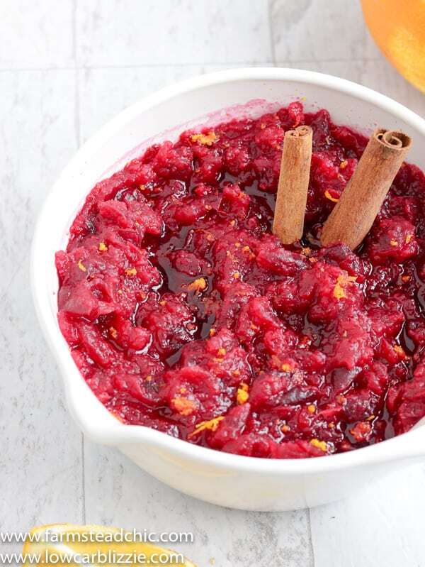 This Low Carb, Keto Cranberry Sauce has a citrus-cinnamon twist and is the perfect complement to your holiday spread. Fresh orange zest and orange extract replace the sugary orange juice found in most cranberry-orange sauces, and a monk fruit blend brings plenty of sweetness without all of those carbs.  #farmsteadchic #cranberrysauce #ketocranberrysauce #lowcarbcranberrysauce #ketoholiday #lowcarbholiday #thanksgivingrecipes #Christmasrecipes #ketothanksgivingrecipes #ketoChristmasrecipes #lowcarbthanksgivingrecipes #lowcarbChristmasrecipes 