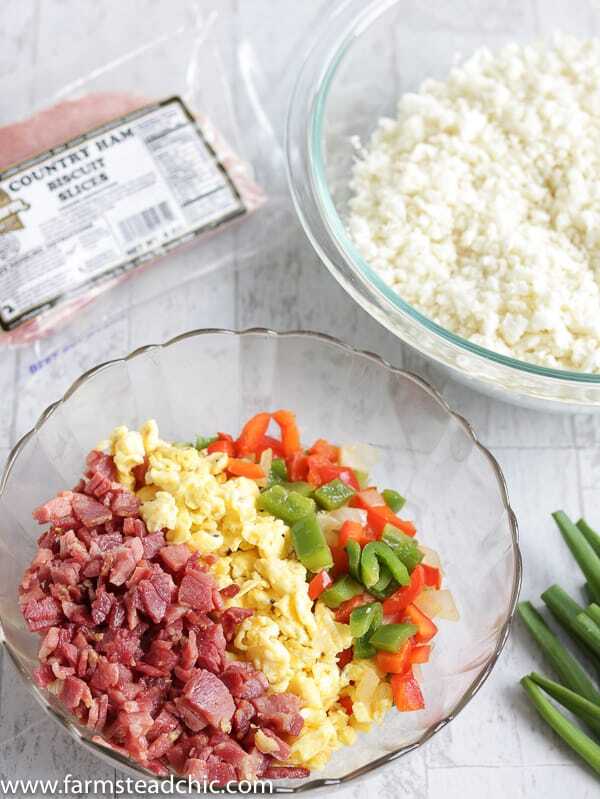 With this Low Carb, Keto Ham Fried Rice (Fried Cauliflower Rice), you can have your takeout and stay low carb too! Freshly riced cauliflower replaces traditional rice, and bell peppers add sweet and savory flavors plus crunch without all the carbs the usual takeout fried rice veggies have. Freshly grated ginger and minced garlic take the whole dish to the next level.  #farmsteadchic #CliftyFarm #countryham #southerncooking #ketofriedrice #lowcarbfriedrice #hamfriedrice