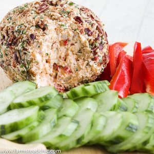 This Low Carb, Keto Pineapple Ham Cheese Ball is a guilt-free, flavorful appetizer for your holiday party. Freshly cooked country ham, toasted coconut, monk fruit, pineapple extract, roasted red peppers, chives, freshly shredded cheddar cheese and hot sauce all come together for a salty, sweet, spicy (low carb) spin on a traditional Hawaiian cheese ball. #farmsteadchic #cliftyfarm #ketocheeseball #lowcarbcheeseball #ketoappetizer #lowcarbappetizer