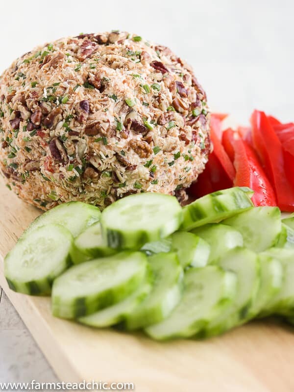 This Low Carb, Keto Pineapple Ham Cheese Ball is a guilt-free, flavorful appetizer for your holiday party. Freshly cooked country ham, toasted coconut, monk fruit, pineapple extract, roasted red peppers, chives, freshly shredded cheddar cheese and hot sauce all come together for a salty, sweet, spicy (low carb) spin on a traditional Hawaiian cheese ball. #farmsteadchic #cliftyfarm #ketocheeseball #lowcarbcheeseball #ketoappetizer #lowcarbappetizer
